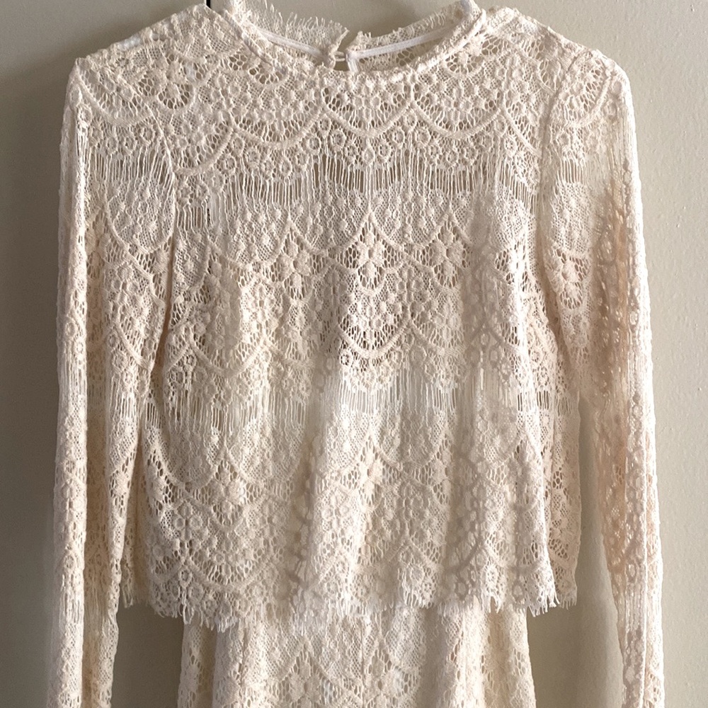 Cream lace romper from anthropology. Flattering xs fit. Quality material.